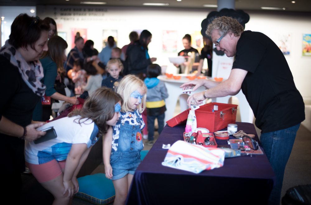 Children meeting panto Dame, Iain Lauchlan at a Family Fun Day