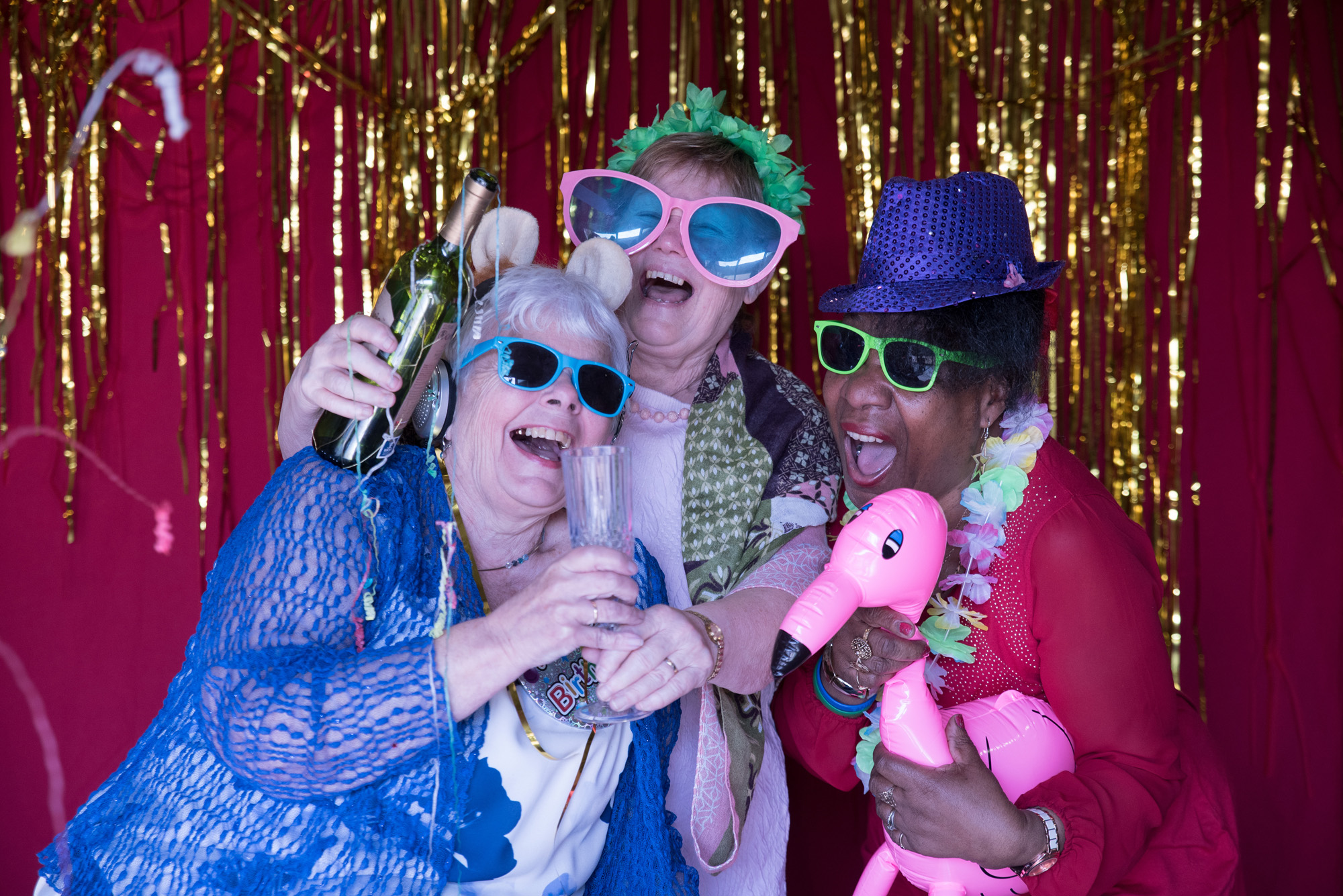 Gill and her fellow participants pose with props for a photo shoot